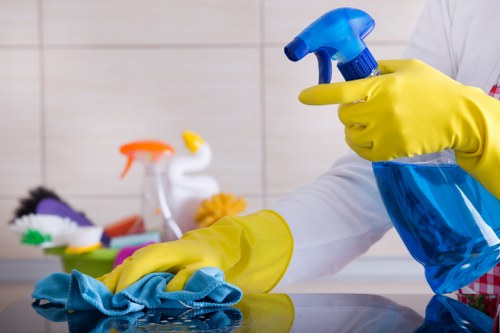 House cleaner tidying up a kitchen area