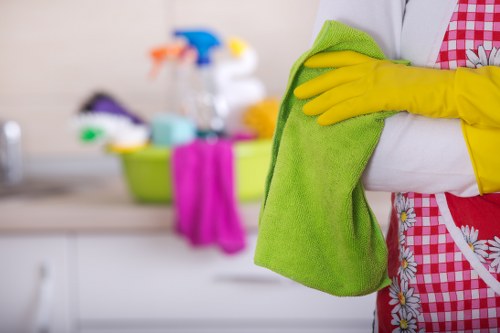 Professional house cleaners cleaning a living room in Queens Park